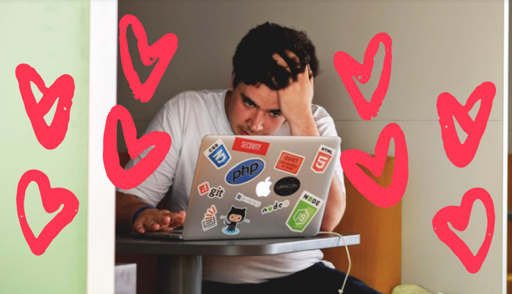A student sat at a laptop surrounded by love hearts